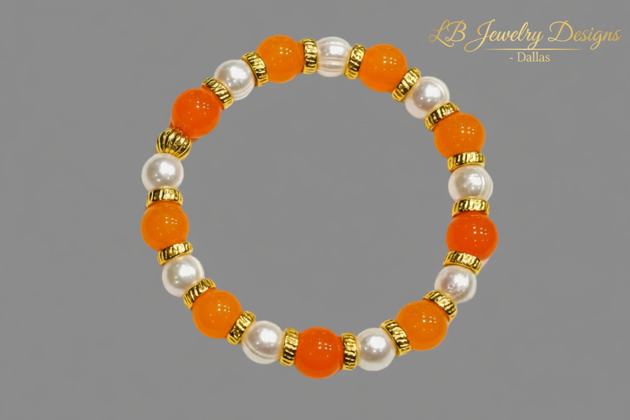 Beaded bracelet with orange, white, and gold beads on a gray background